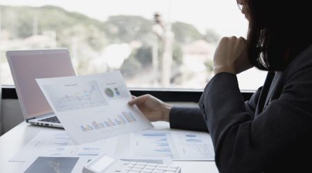 Financial businesswomen analyze the graph of the company's performance to create profits and growth, Market research reports and income statistics, Financial and Accounting concept.